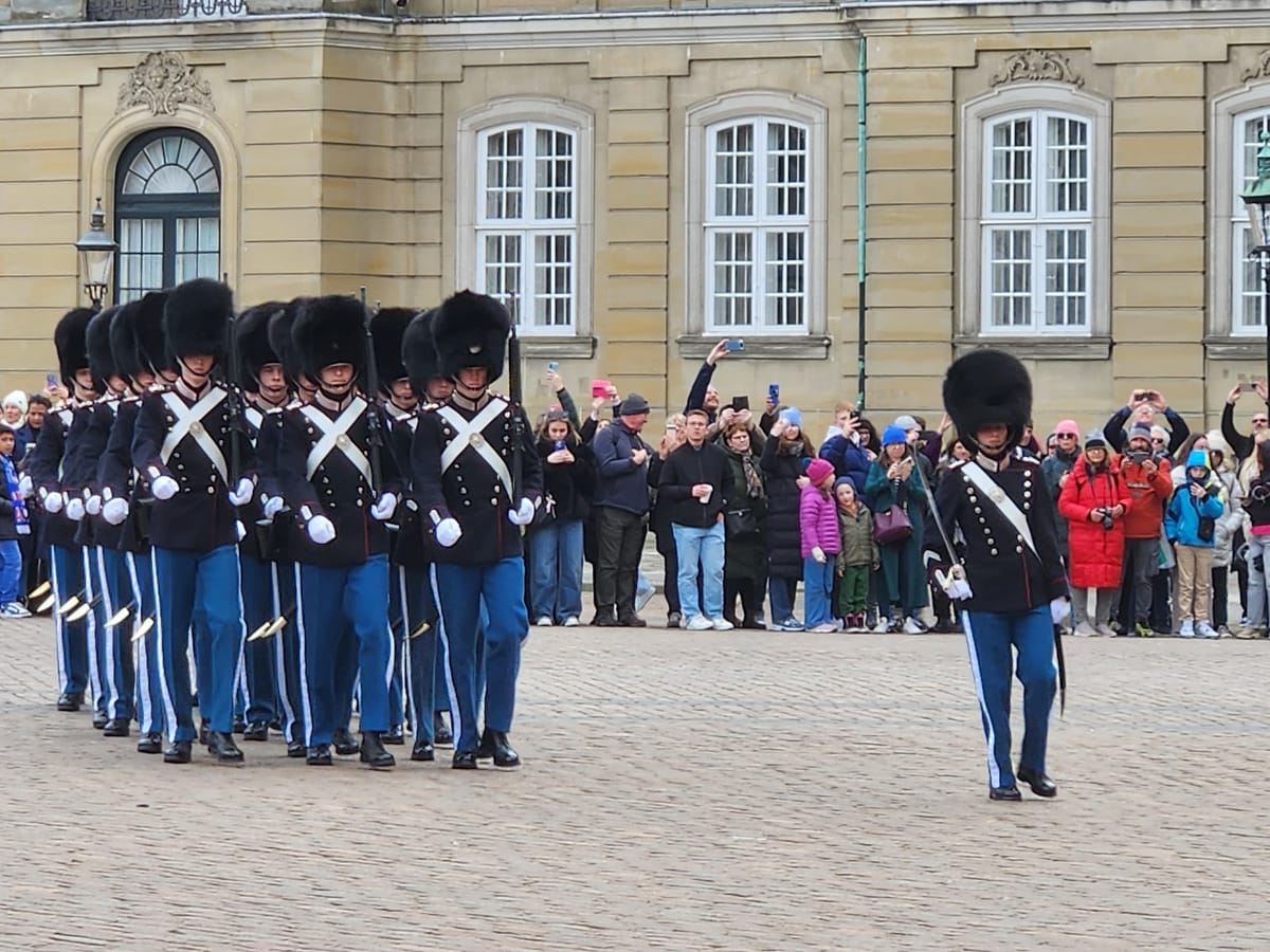 The Royal Life Guards in bearskin hats marching past the crowd at Amalienborg Palace