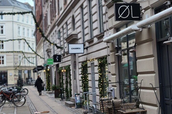Small shops and cafés on a cobbled side street in Nørrebro